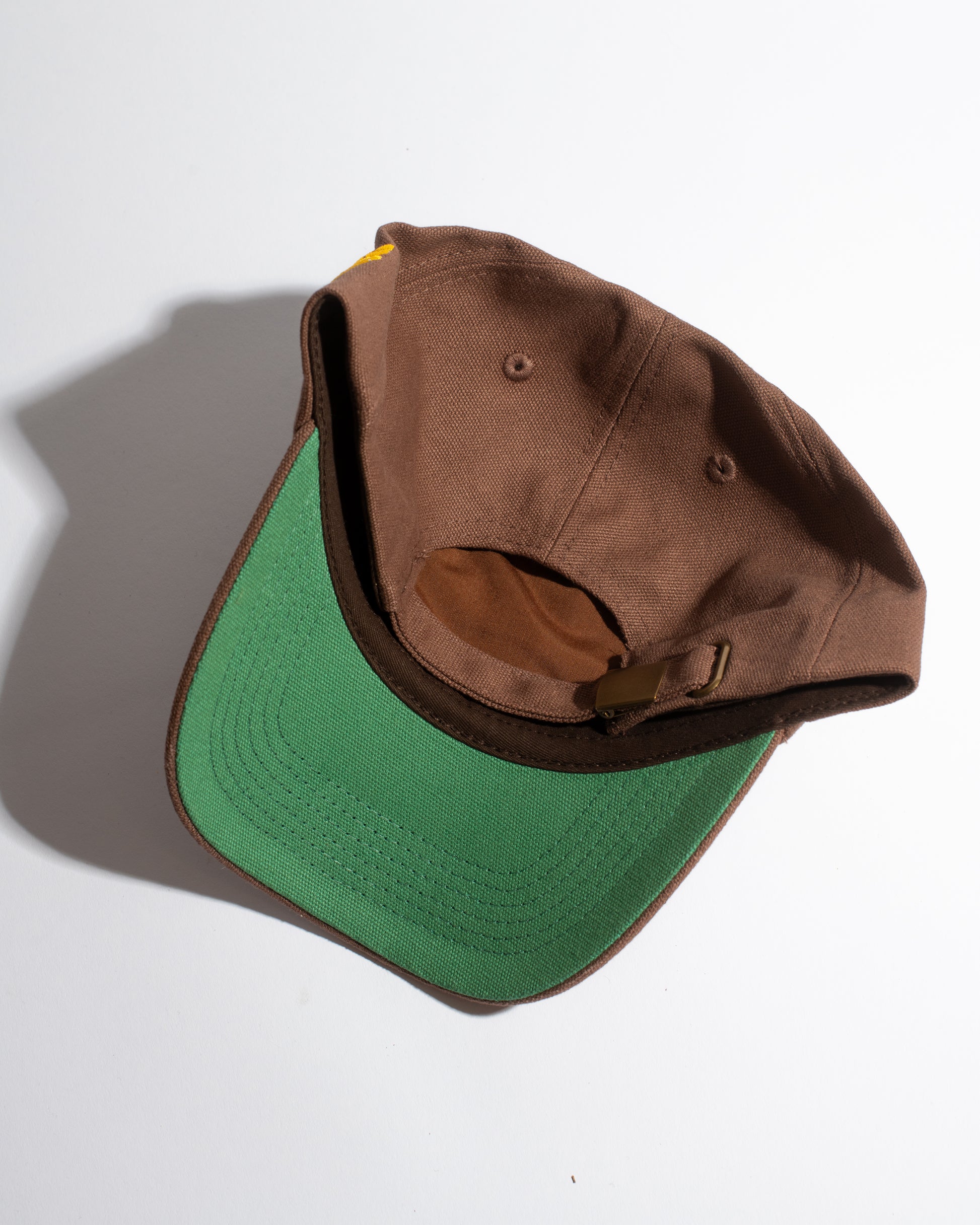 Brown and green cap on a white background