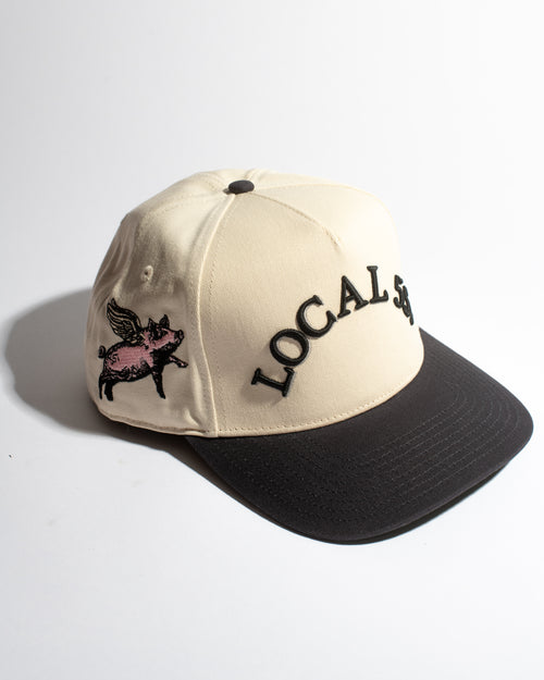 Beige and navy cap with 'LOCAL' and pig graphic on a white background