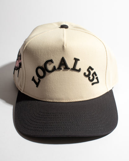 Beige and navy cap with 'LOCAL 557' text on a white background